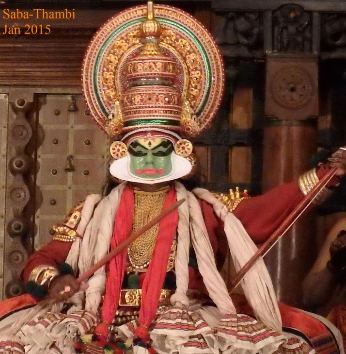 Kathakkali dancer with a circular (white) extension to his face (Kerala, India)